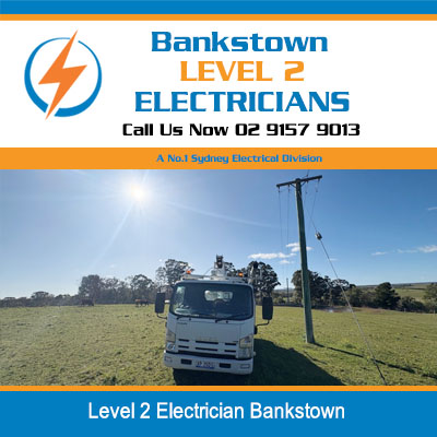 Level 2 electricians service truck of parked in open field near power pole in Bankstown